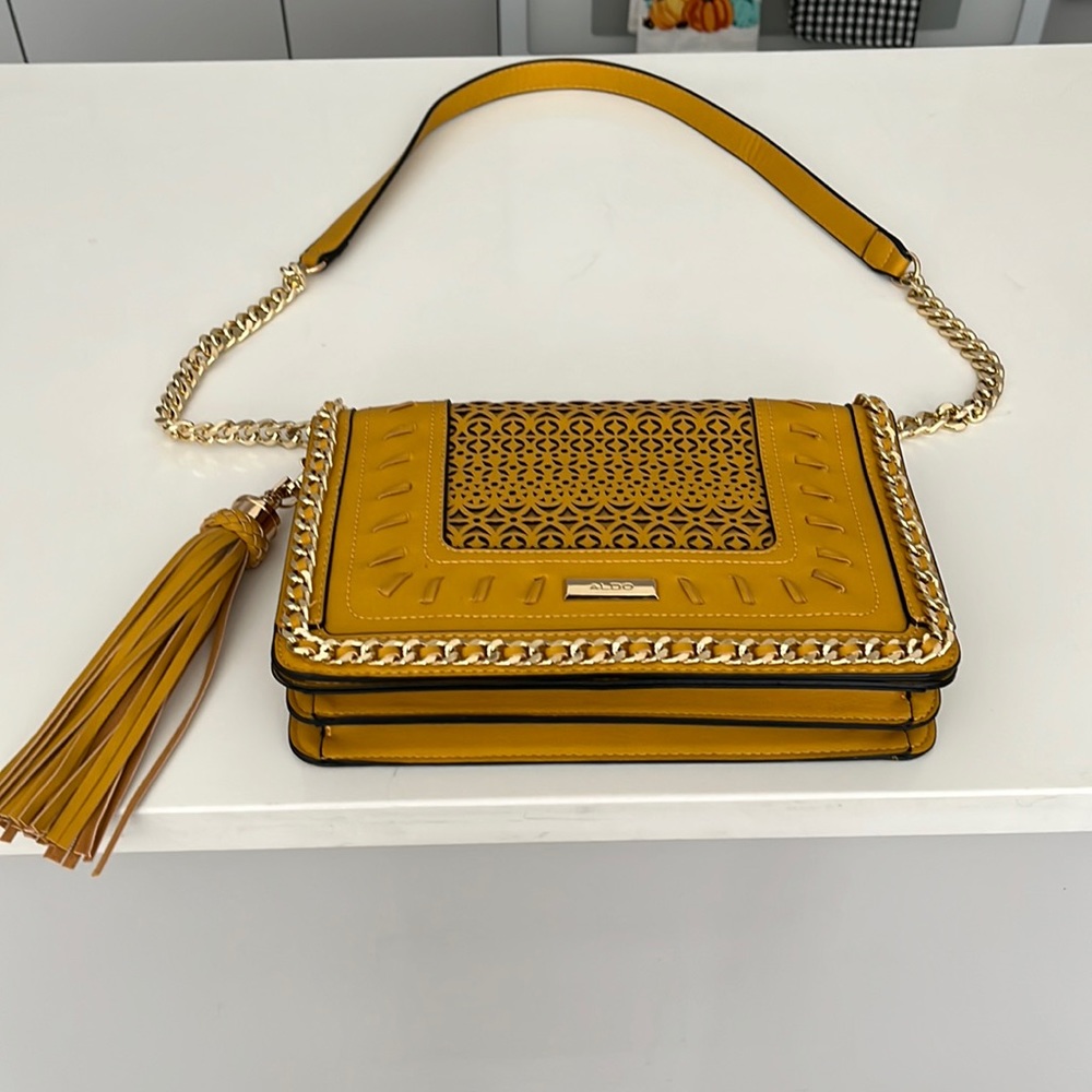 Detailed bag with gold chain strap/ zipper pocket and cell phone pockets inside.